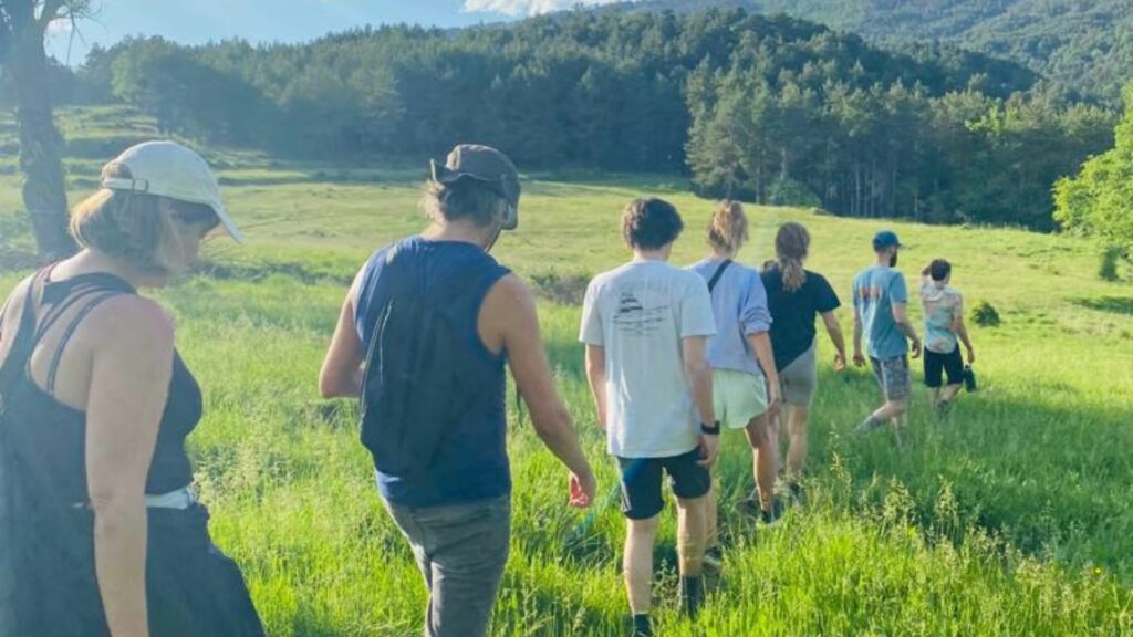 alt="Coworkers in a coworking community getaway hiking in Catalonia"