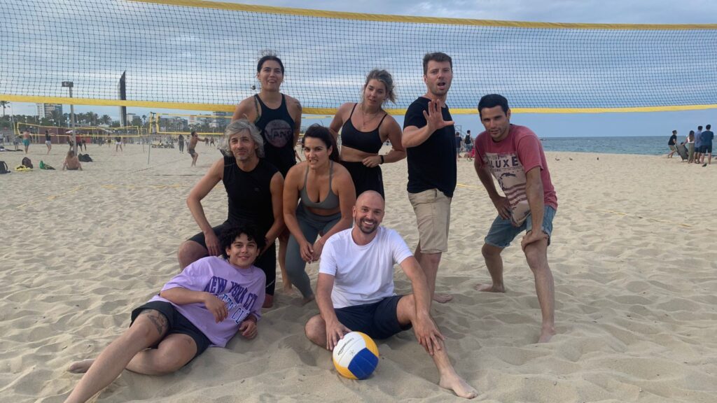 alt="coworkers playing beach volley in Barcelona"