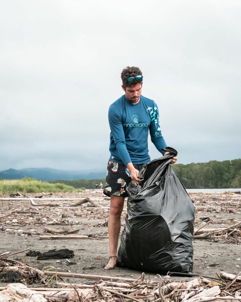 marine activist picking up trash on a beach